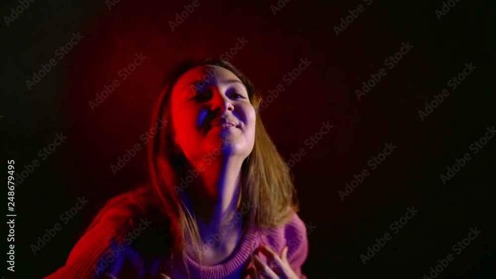 Cheerful girl posing in studio wearing pink sweater, happy woman moving while posing. Cheerful girl posing in studio wearing pink sweater, happy woman moving while posing.