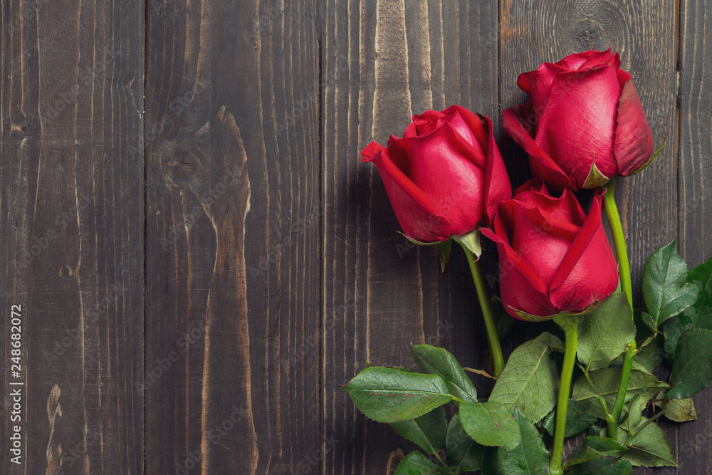 Bouquet of red rose flower on dark wooden table. Can use for valentine day concept or background. Bouquet of red rose flower on dark wooden table. Can use for valentine day concept or background.