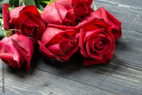 Bouquet of red rose flower on dark wooden table. Can use for valentine day concept or background.