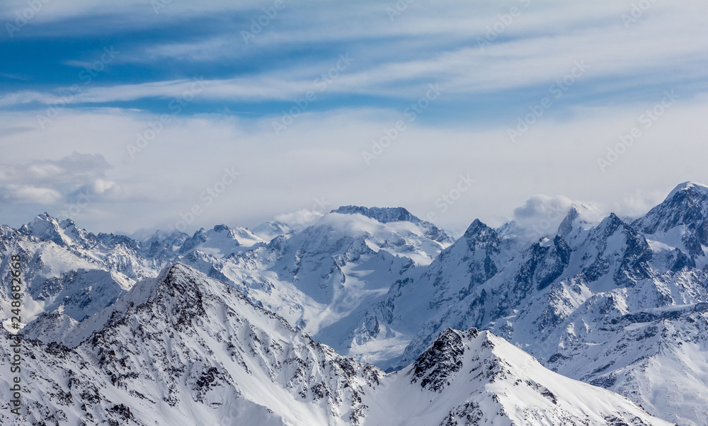 Obraz premium Snowy Mountains in blue and white sky