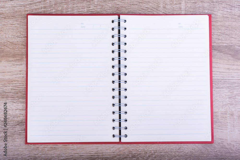 Top view of Open diary or note book put on wooden table. Top view of Open diary or note book put on wooden table.