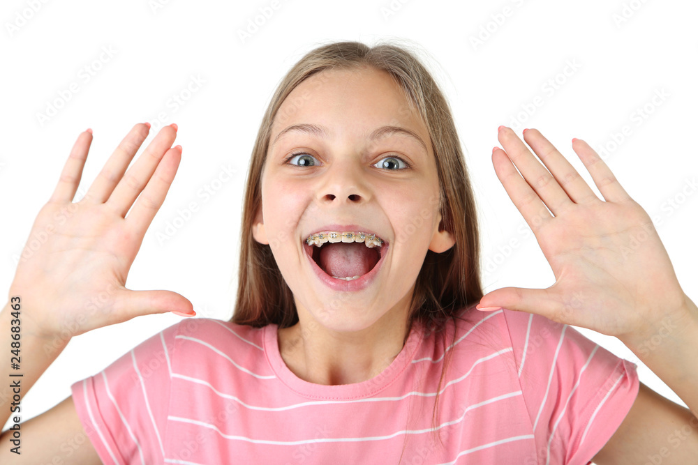 Young smiling girl with dental braces on white background Young smiling girl with dental braces on white background
