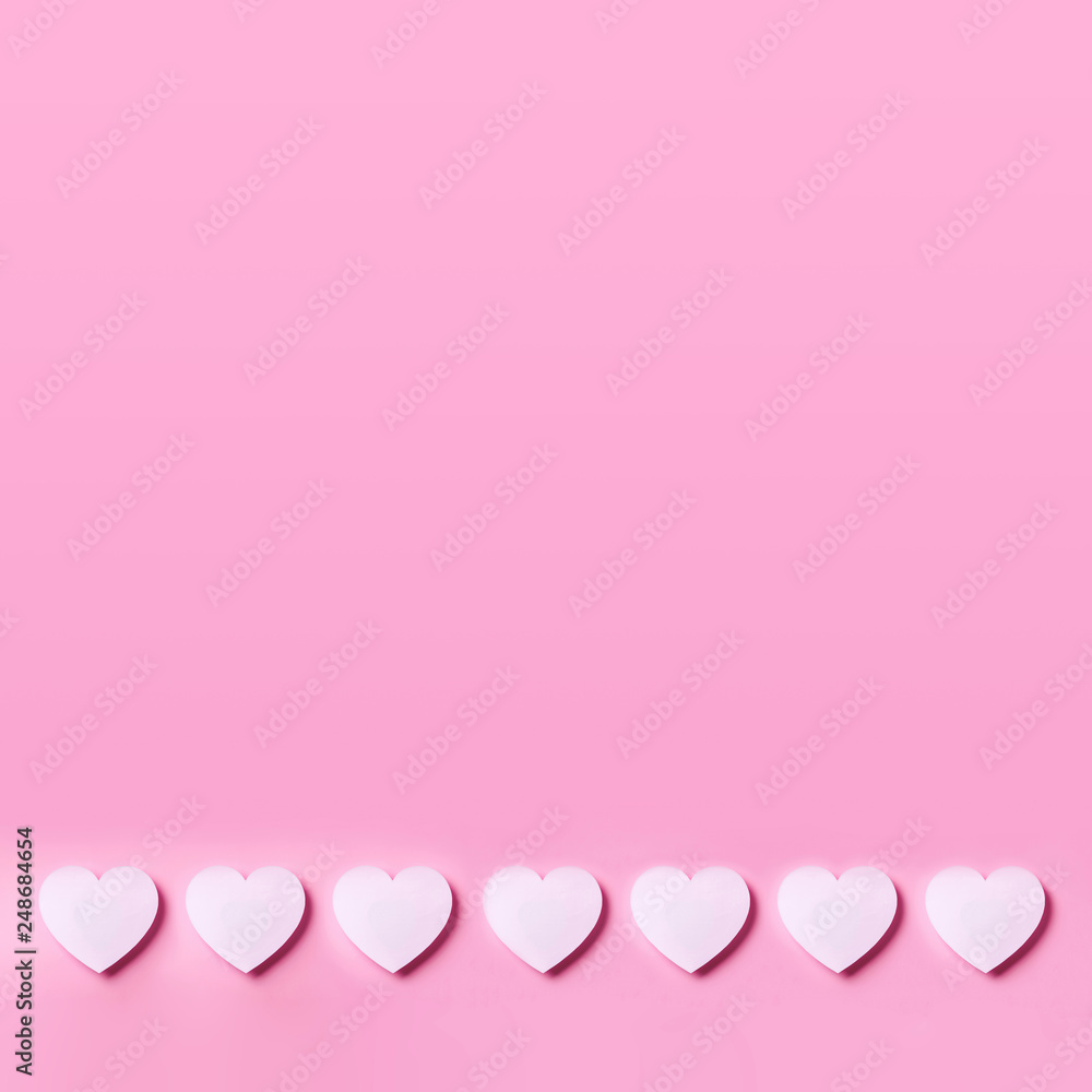 Seamless pattern of white hearts on pink punchy pastel background. Top view. Valentine's Day. Love, date, romantic concept. Square crop