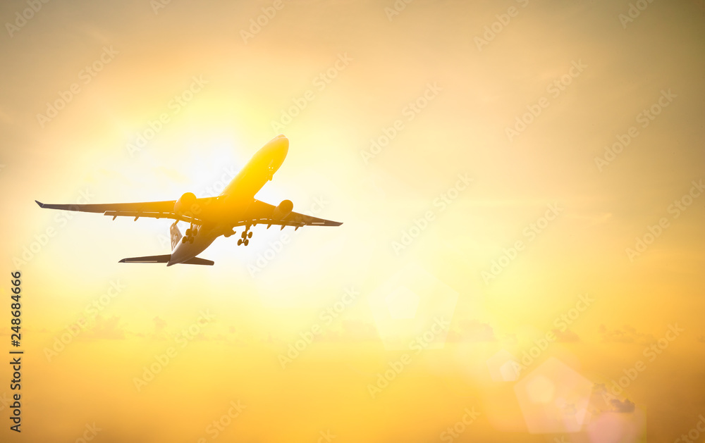 Airplane flying above the clouds in the sunset sky background. Transportation or Logistic concept.