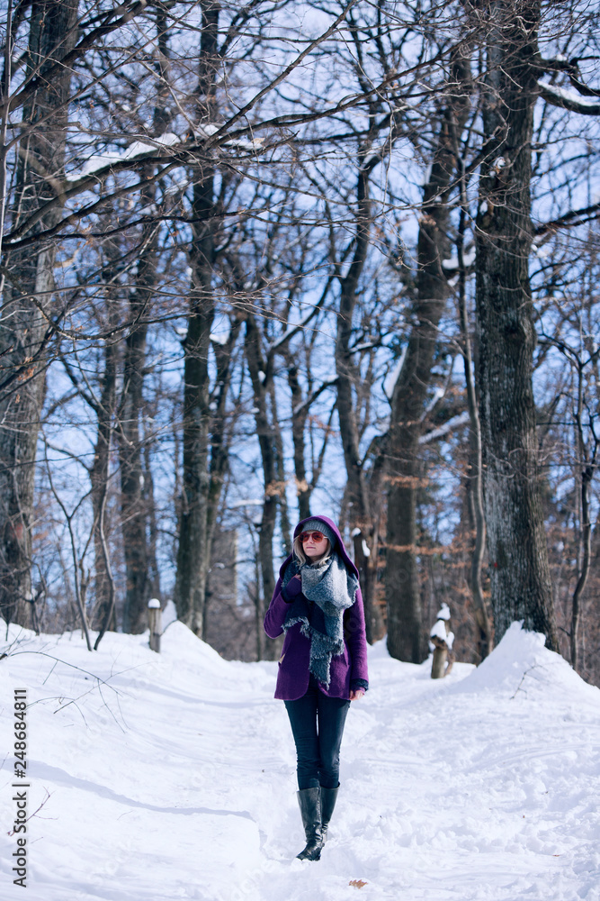 woman walking in snowy forest