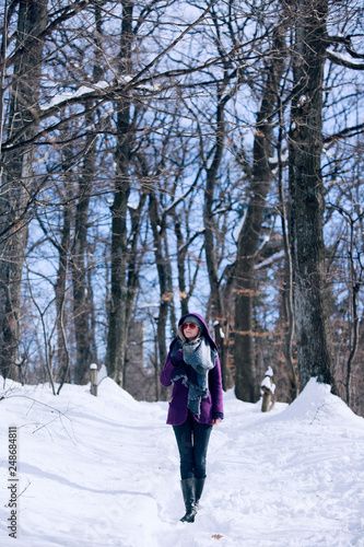 woman walking in snowy forest
