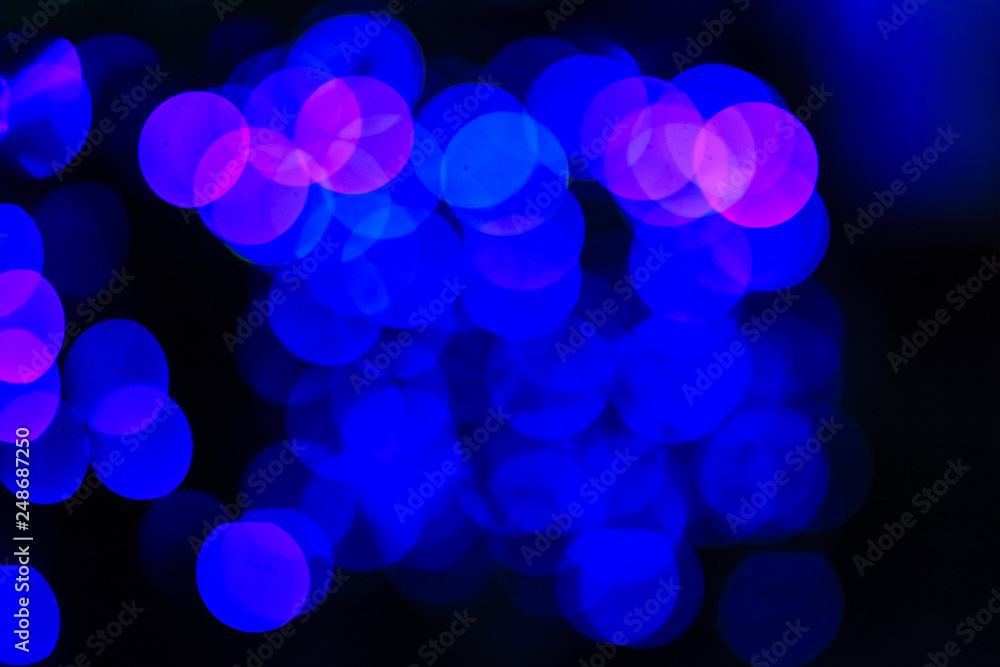 Beautiful blue bokeh abstract light background. Wonderful Defocused abstract blue christmas background. Abstract christmas lights as background in the night with noise grain and poor light. Beautiful blue bokeh abstract light background. Wonderful Defocused abstract blue christmas background. Abstract christmas lights as background in the night with noise grain and poor light.