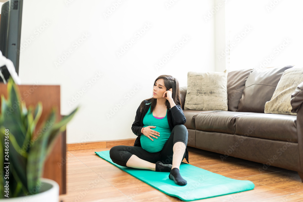 Fototapeta premium Exhausted Woman Touching Pregnant Belly