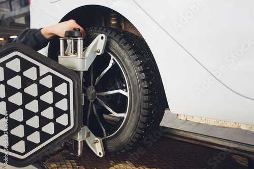 A Car on the Car Steering Wheel Balancer and Calibrate with laser reflector attach on each tire to center driving adjust in the garage.