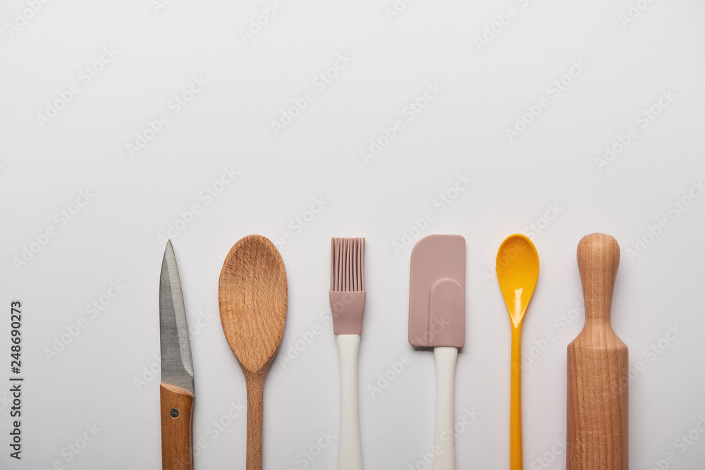 top view of cooking utensils on grey background with copy space top view of cooking utensils on grey background with copy space