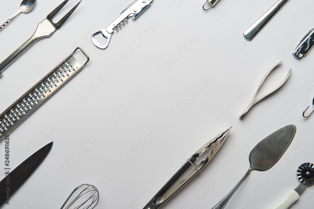 flat lay with metal cooking utensils on grey background with copy space flat lay with metal cooking utensils on grey background with copy space