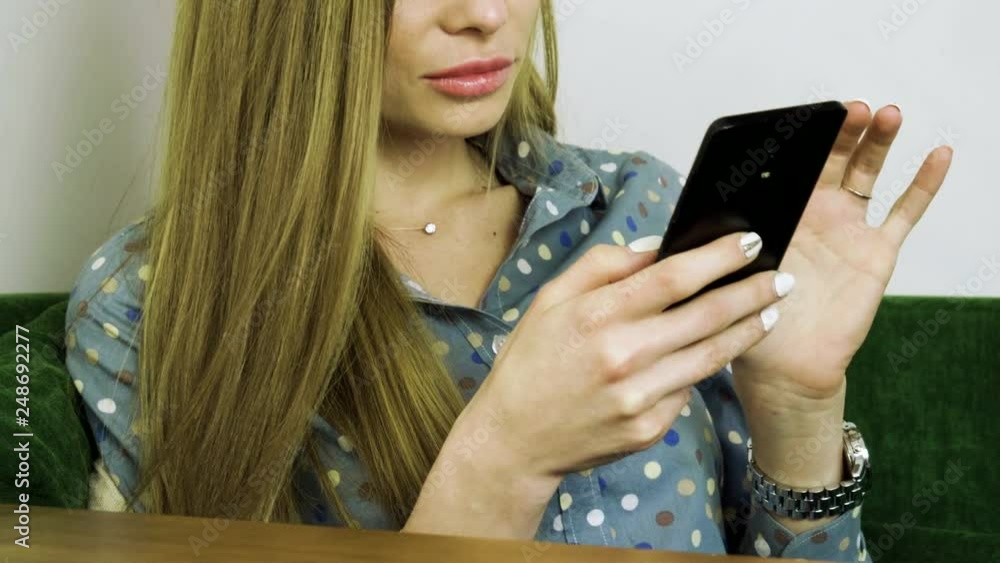 Attractive young happy woman using mobile phone during resting in a cafe. 4K Attractive young happy woman using mobile phone during resting in a cafe. 4K