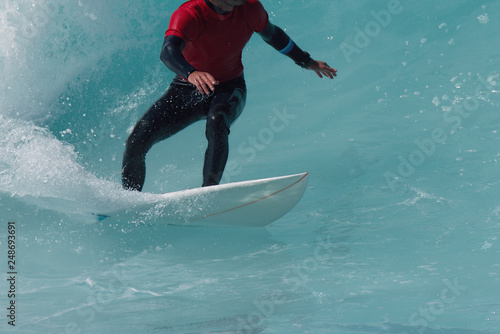 Sports man surfing wave on surfboard in ocean