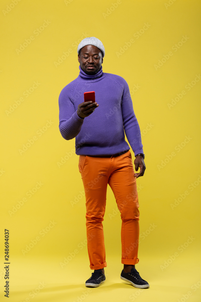 Attentive young man staring at screen of his gadget Attentive young man staring at screen of his gadget