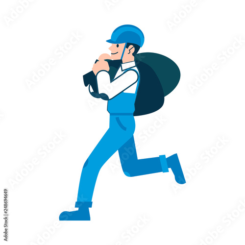 A man or worker in a helmet is carrying sacks and bags.