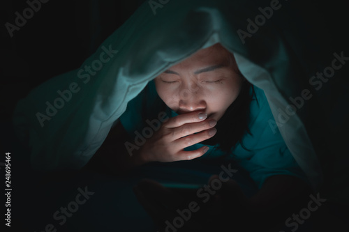 Asian woman play smartphone in the bed at night,Thailand people,Addict social media,Play internet all night,Lychnobite © reewungjunerr