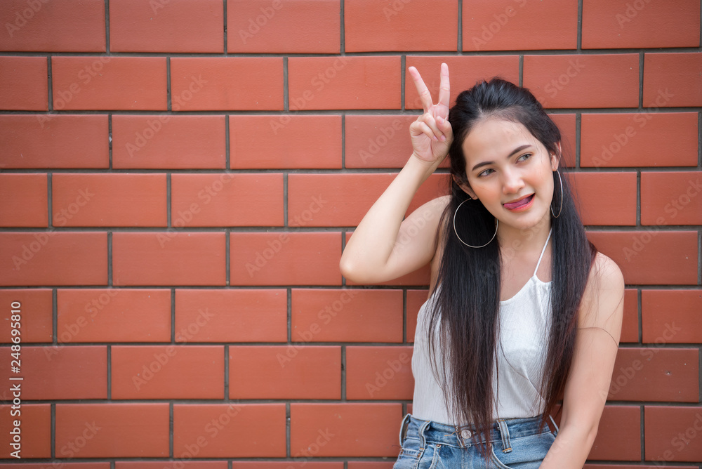 Portrait of beautiful asian chic girl pose for take a picture on wall background,Lifestyle of teen thailand people,Modern woman happy concept,Punk rock style Portrait of beautiful asian chic girl pose for take a picture on wall background,Lifestyle of teen thailand people,Modern woman happy concept,Punk rock style