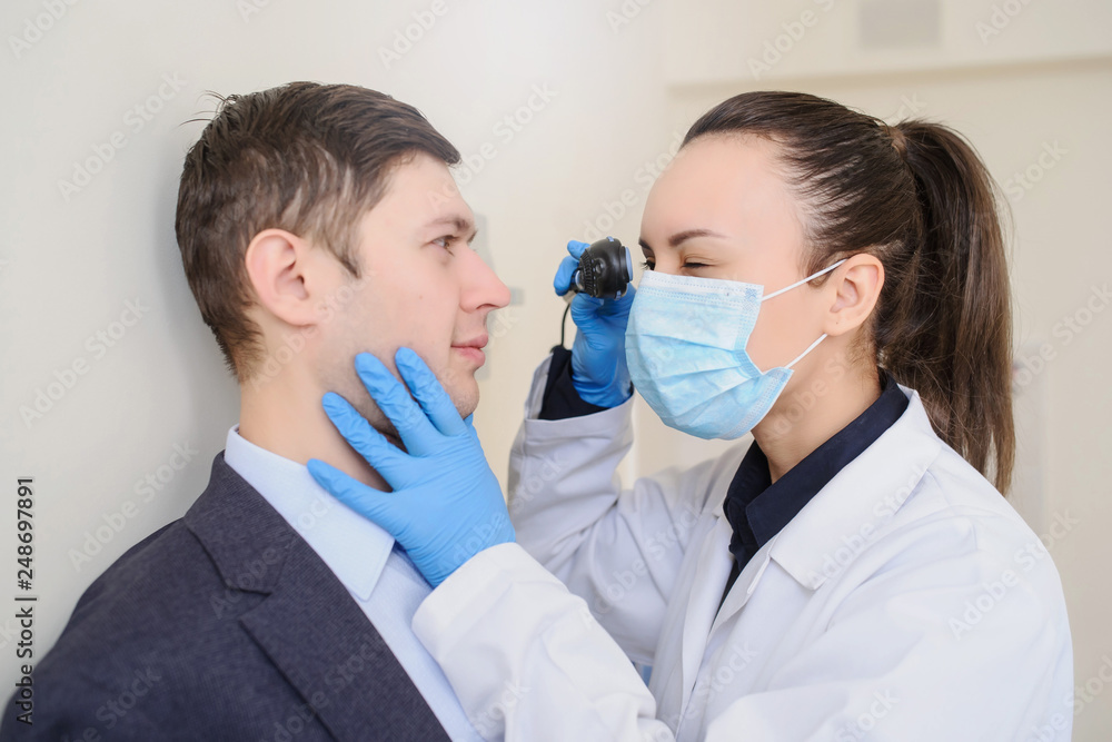 close up photo of a optometrist examining man's eyes with ophthalmoscope close up photo of a optometrist examining man's eyes with ophthalmoscope