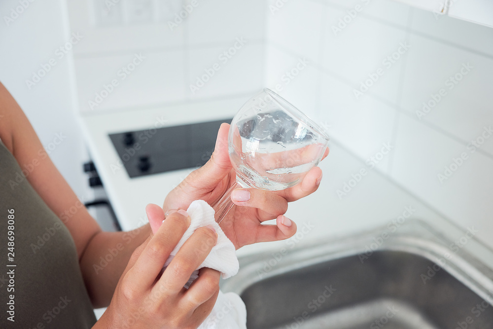 Close up of woman hands washing dishes.