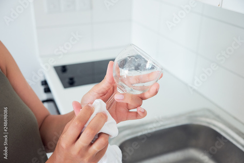 Close up of woman hands washing dishes.