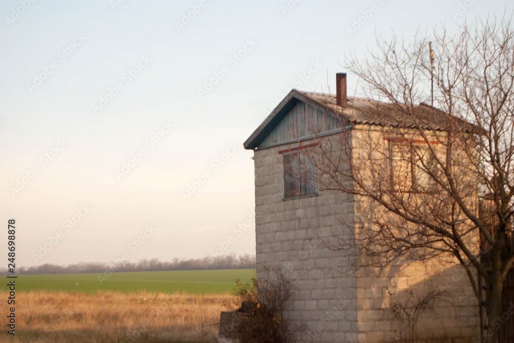 landscape. green field with farm house on the outskirts landscape. green field with farm house on the outskirts