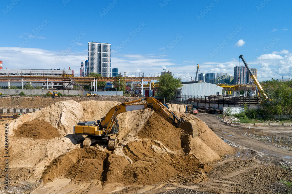Tracked excavator overloads the sand from the embankment Tracked excavator overloads the sand from the embankment