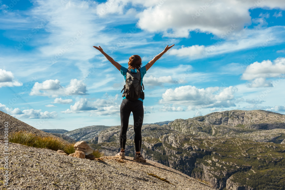Woman successful hiking silhouette in mountains, motivation and inspiration in beautiful sunset. Female hiker with arms up outstretched on mountain top, inspirational landscape Woman successful hiking silhouette in mountains, motivation and inspiration in beautiful sunset. Female hiker with arms up outstretched on mountain top, inspirational landscape