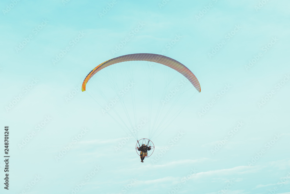 Paraglider flying in the blue sky Paraglider flying in the blue sky