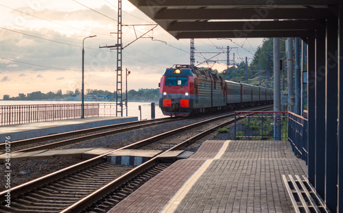 passenger train on the railway tracks approaching the station