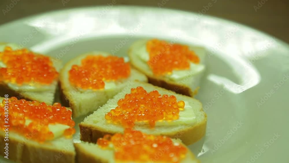 White plate of canapes with red caviar White plate of canapes with red caviar