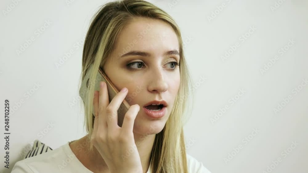 Beautiful woman using mobile phone in modern cafe and talking on the cell phone. 4K Beautiful woman using mobile phone in modern cafe and talking on the cell phone. 4K