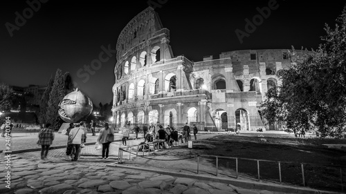 Photography Roman Colosseum and tourists as night falls in Rome, Italy, black and white, peo