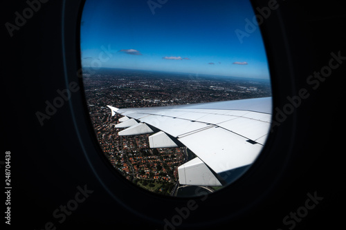 Image out of an Airplane window, Clouds and sky as seen through window of an aircraft, view on earth from the window of the airplane.