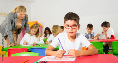 Boy drawing in schoolroom