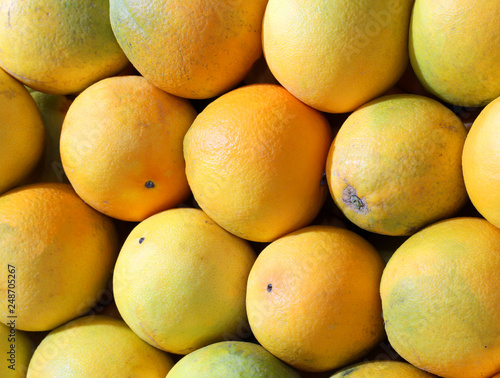 background of many organic oranges for sale at market