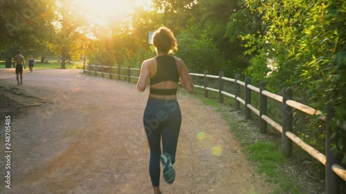 Beautiful Female Runs At Sunset On Trail