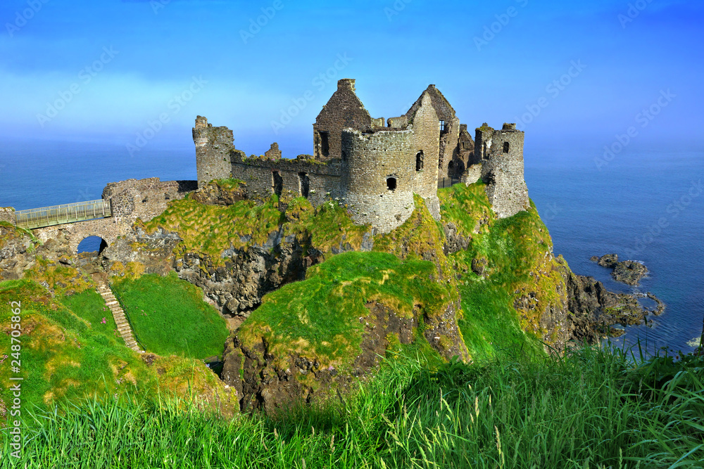 Ruins of the medieval Dunluce Castle overlooking the scenic cliffs of the Causeway Coast, Northern Ireland