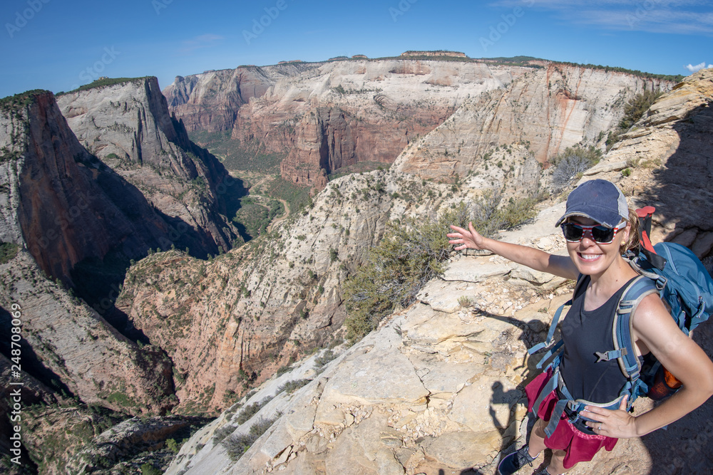 Fisheye wide angle view of the Zion National Park Observation Point Trail in Utah, with a woman hiker on the trail Fisheye wide angle view of the Zion National Park Observation Point Trail in Utah, with a woman hiker on the trail
