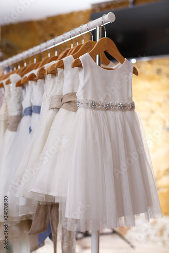 Kids white dresses on hangers