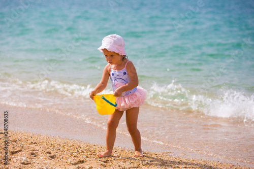 Cute little girl playing on the seashore