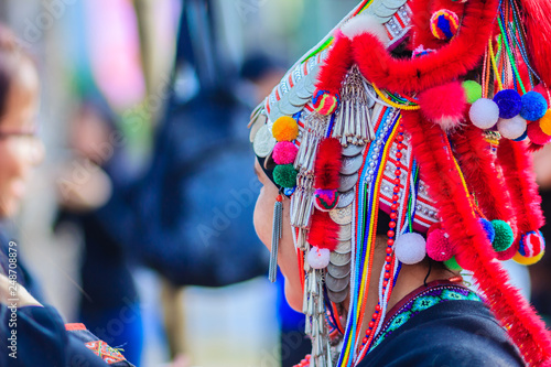 Konstfotografi Beautiful traditional red costumes clothes and silver coins on headdress in hill tribe minority village at northern Thailand