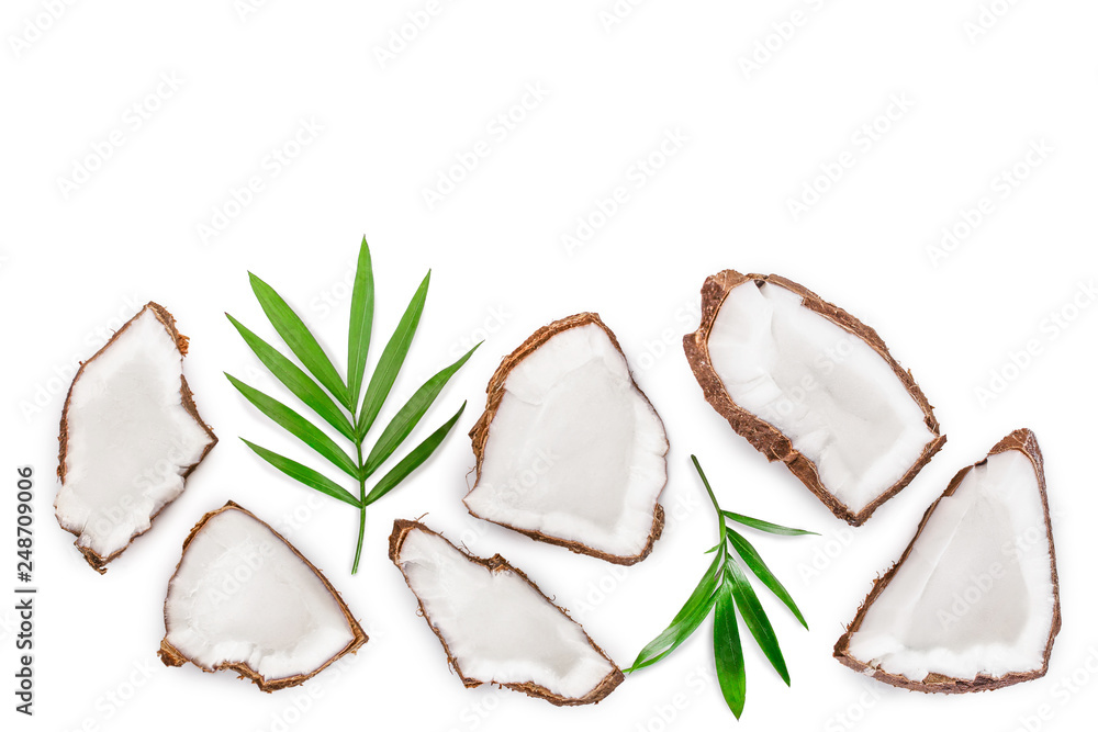 piece of coconut with leaves isolated on white background with copy space for your text. Top view. Flat lay piece of coconut with leaves isolated on white background with copy space for your text. Top view. Flat lay