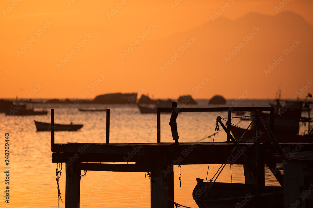 beautiful sunset on the pier of the guaratiba stone (pedra de guaratiba), in the west side of rio de janeiro, brazil beautiful sunset on the pier of the guaratiba stone (pedra de guaratiba), in the west side of rio de janeiro, brazil