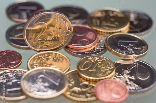 Various euro coins. Stacked euro coins of different values on gray background. Tool of finances, marketa, transfers, investments, savings and business photo