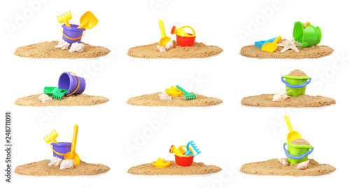 Set of sand piles with different plastic toys on white background. Beach accessories