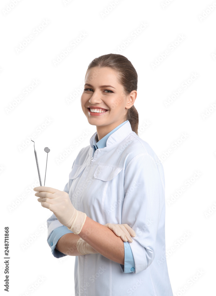 Female dentist holding professional tools on white background Female dentist holding professional tools on white background