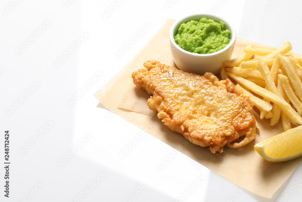 British Traditional Fish and potato chips on white background British Traditional Fish and potato chips on white background