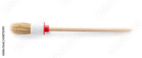 Thin wooden paint brush on white background