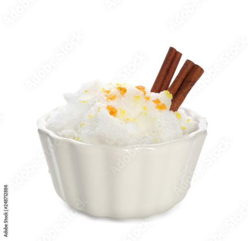 Snow ice cream with sprinkles and cinnamon in bowl on white background