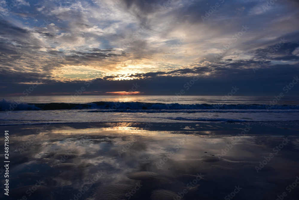 Dramatic reflection of clouds at sunset